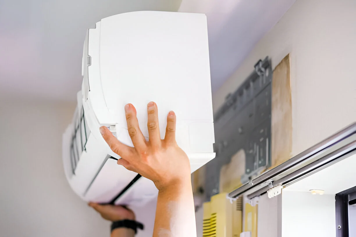 Home 13 Technician performing a quick AC fix on a residential air conditioner
